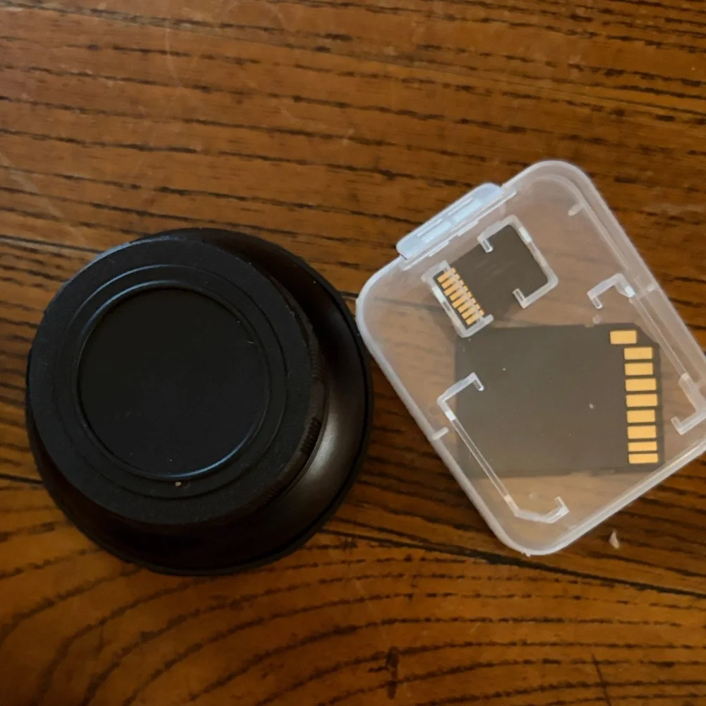Black Compact Digital Camera with Lens Cap and SD Card